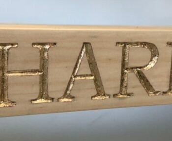 Olivia O'Conor letter wood carving detail with gold leaf